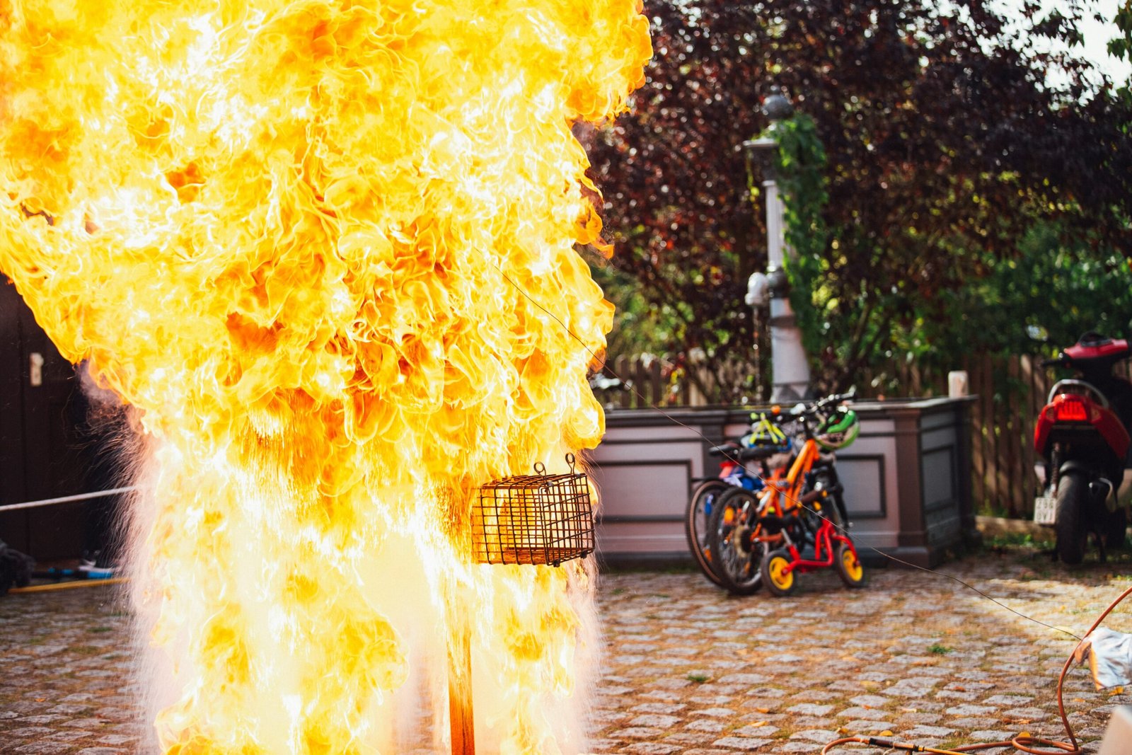 two bikes parking near wall beside big fire