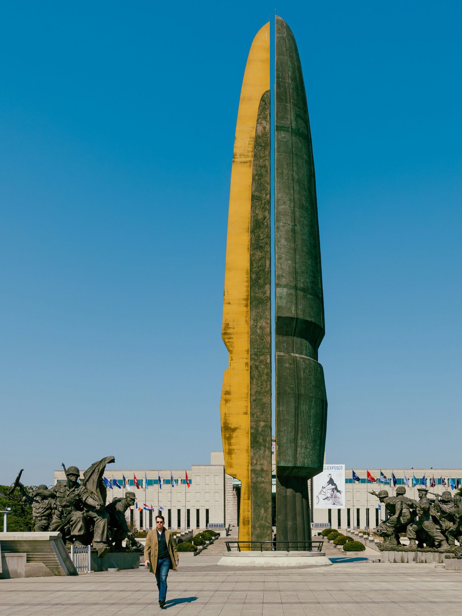 A man walks past a monumental sculpture.